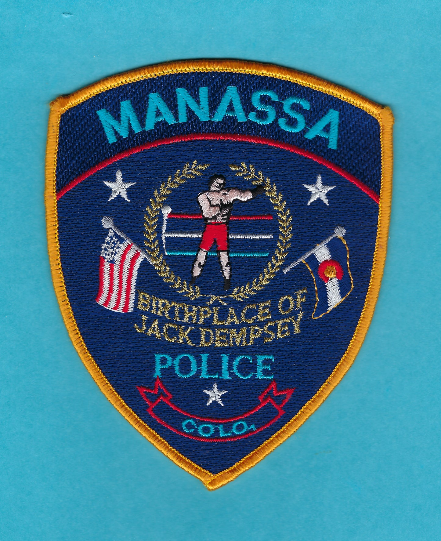 MANASSA, COLORADO ( BIRTHPLACE OF JACK DEMPSEY ) POLICE DEPARTMENT 5-INCH EMBROIDERED PATCH BY PUBLIC SAFETY COLLECTIBLES.
