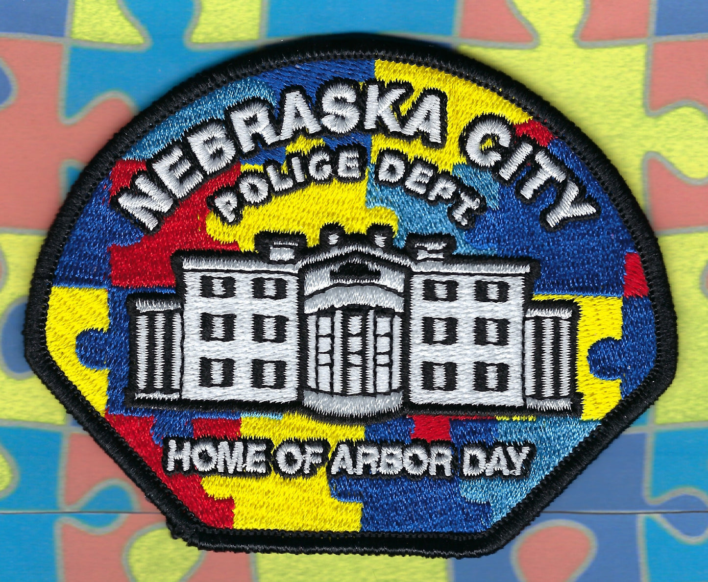 NEBRASKA CITY, NEBRASKA POLICE DEPARTMENT AUTISM AWARENESS EMBROIDERED PATCH DESIGNED AND PRODUCED BY GHOST PATCH ENTERPRISES.